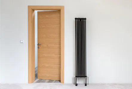 A light wood single leaf hinged door.