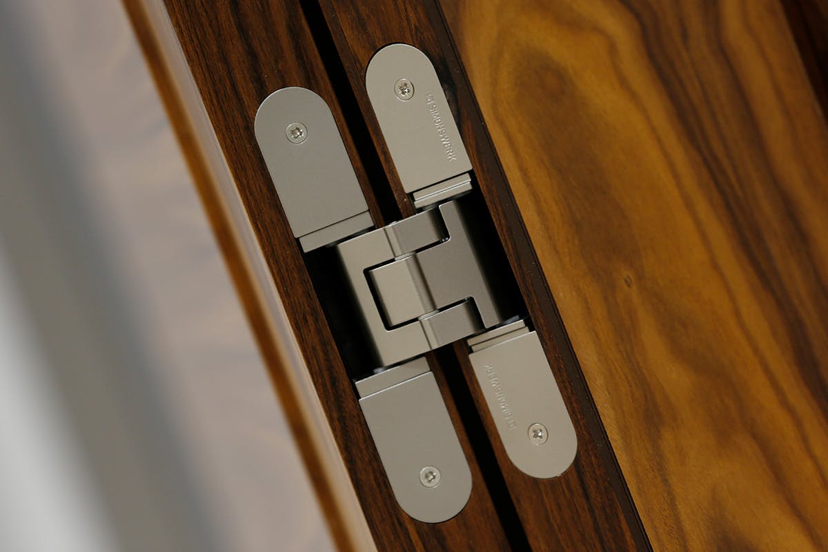 Close-up of a Simonswerk Tectus Hinge in stainless steel.