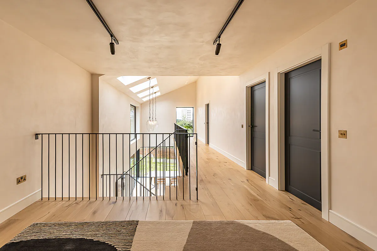 Landing with balcony. Featuring 3 pre-hung internal door sets by Deuren - Victorian style with dark grey paint finish.