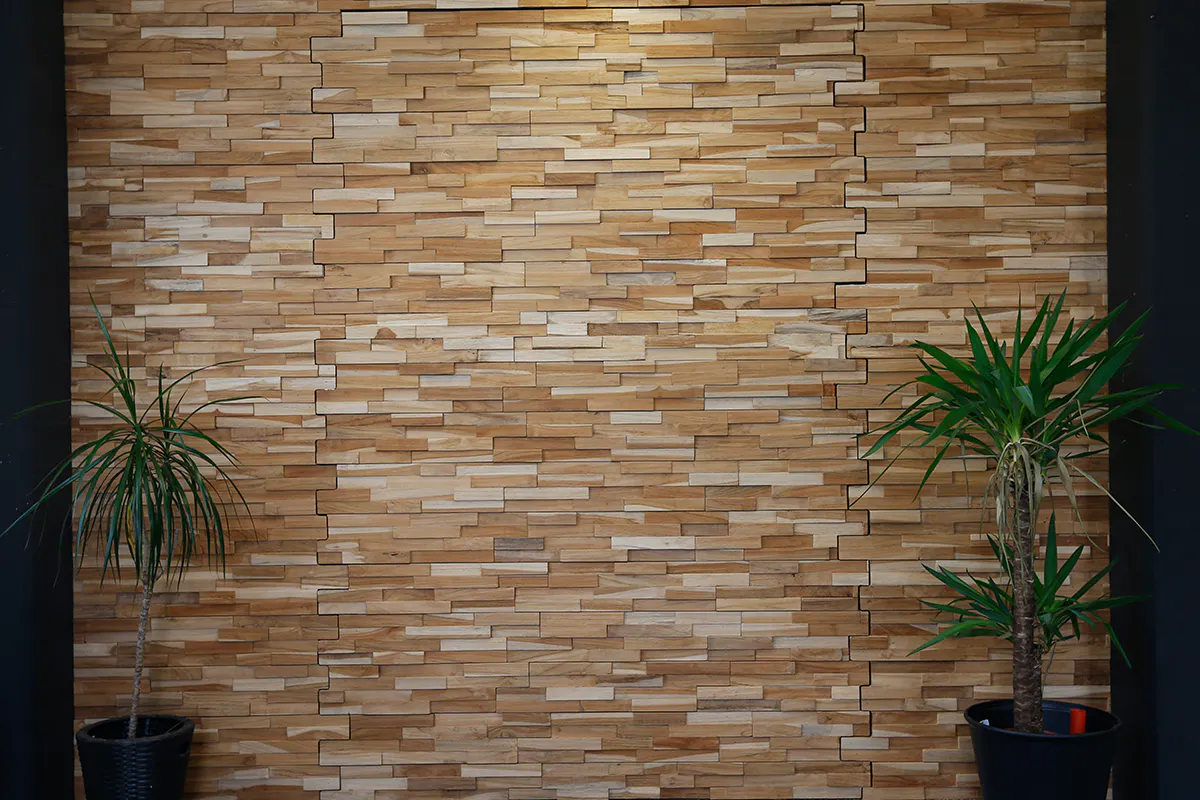 A bespoke secret pivot door by Deuren. The door and surrounding wall surfaces are finished in stacked timber blocks. The door is disguised into the wall.