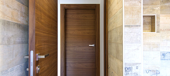 A brown wooden single leaf hinged door.