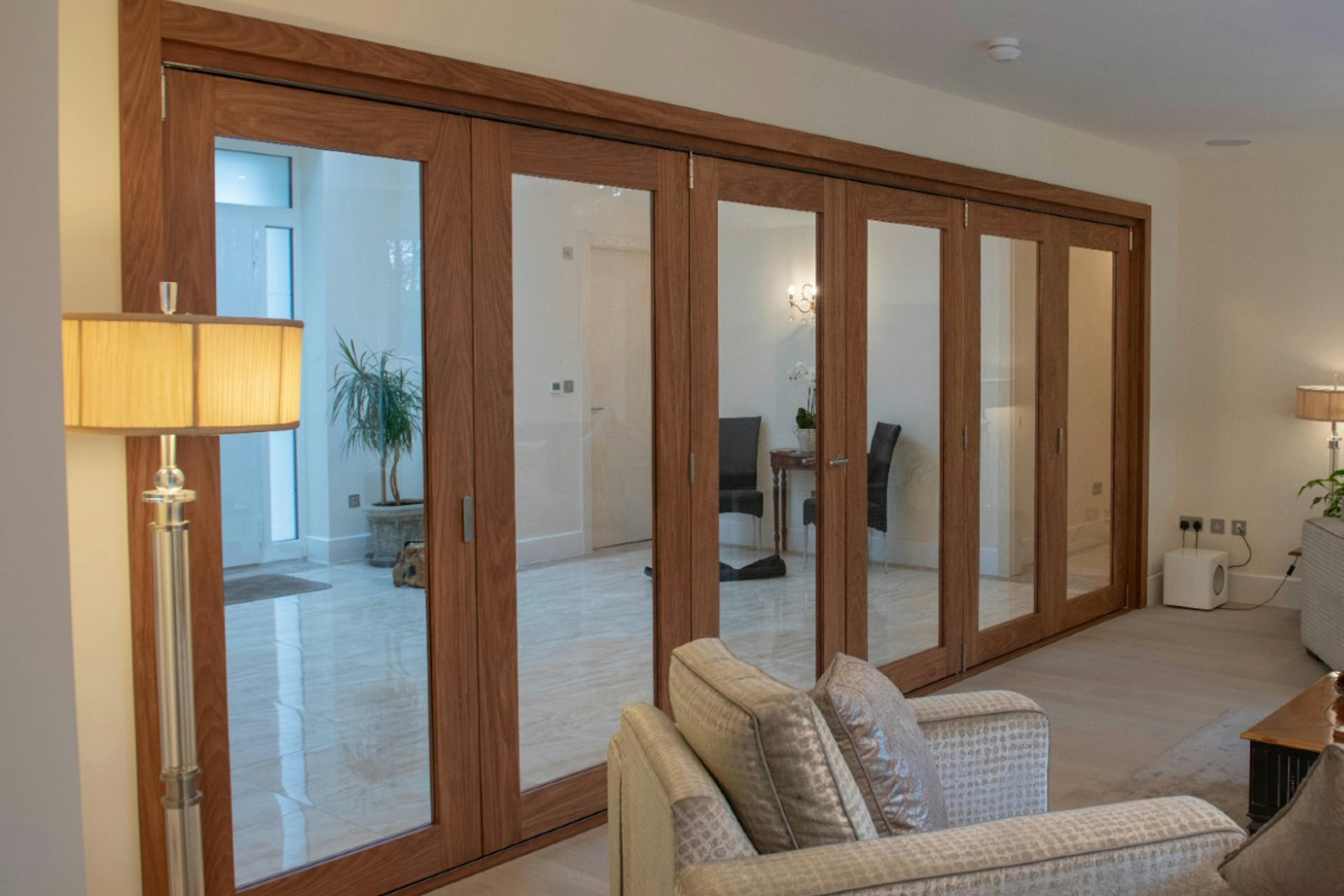 internal bi-folding doors with 6 glazed door leaves - Gio Glazed in oak finish
