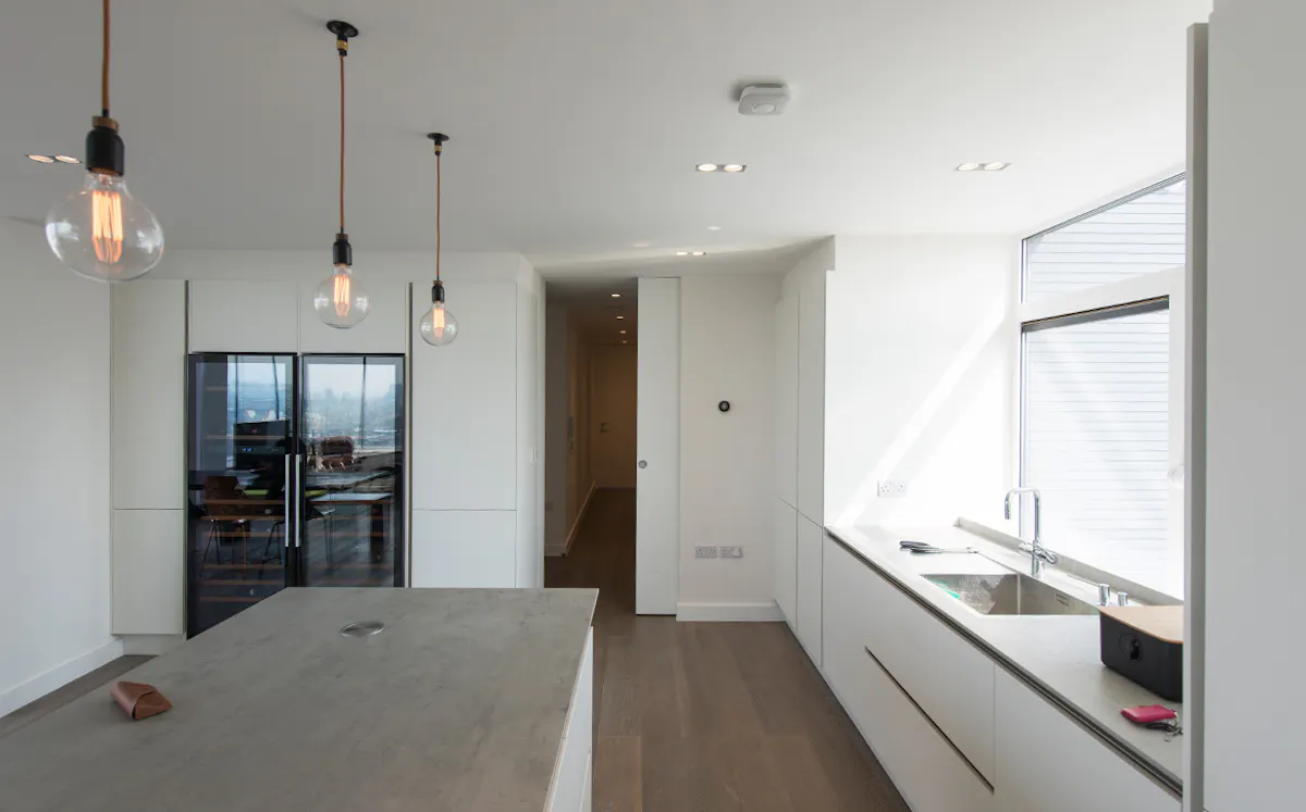 Floor to ceiling pocket door by Deuren in Trem pwhite painted finish