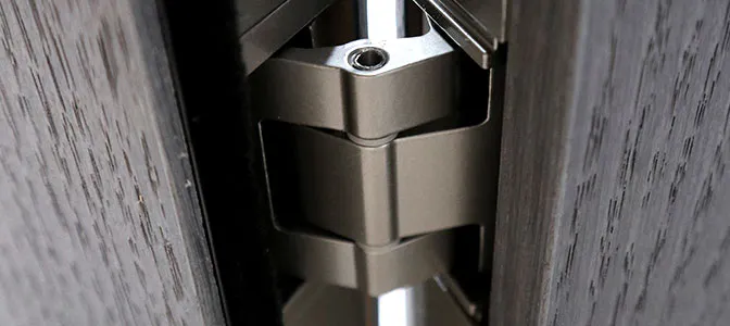 A close up of a hinge set into a wooden interior bi-fold door.