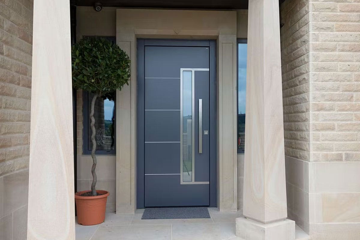 Modern front door made by Deuren - Pianura 2 style with a vertical glazed panel along side a long bar handle. Has 4 evenly spaced horizontal stainless steel inlays