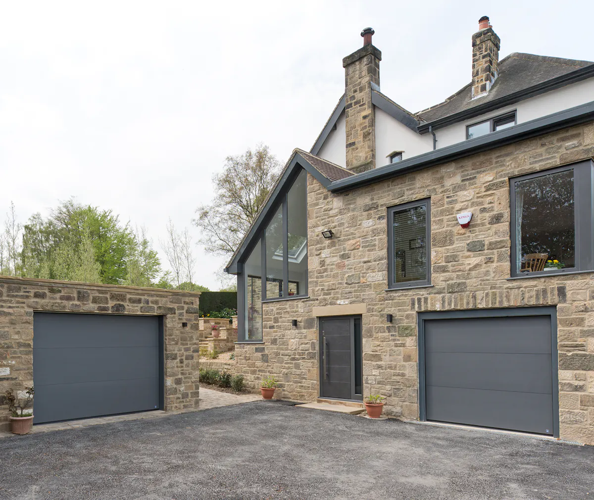 Modern house with grey matching front and garage doors