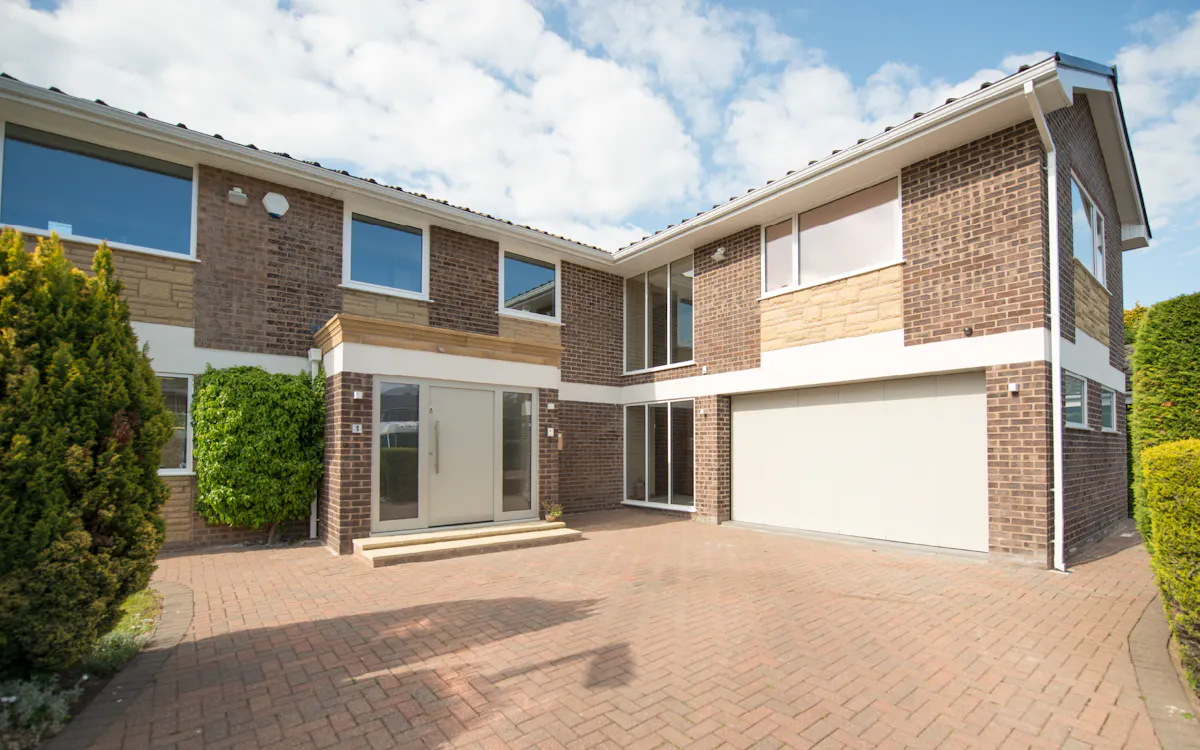 A house with matching white modern front door and garage doors.