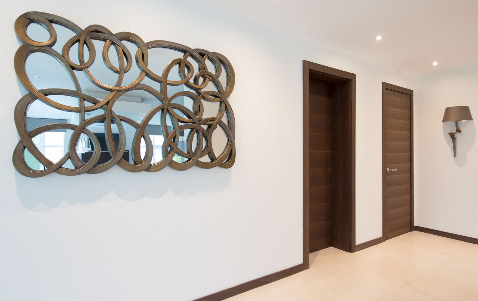 Light and airy hallway with sculptural mirror on the wall and two modern internal door sets by Deuren - Trem H, Wenge finish.