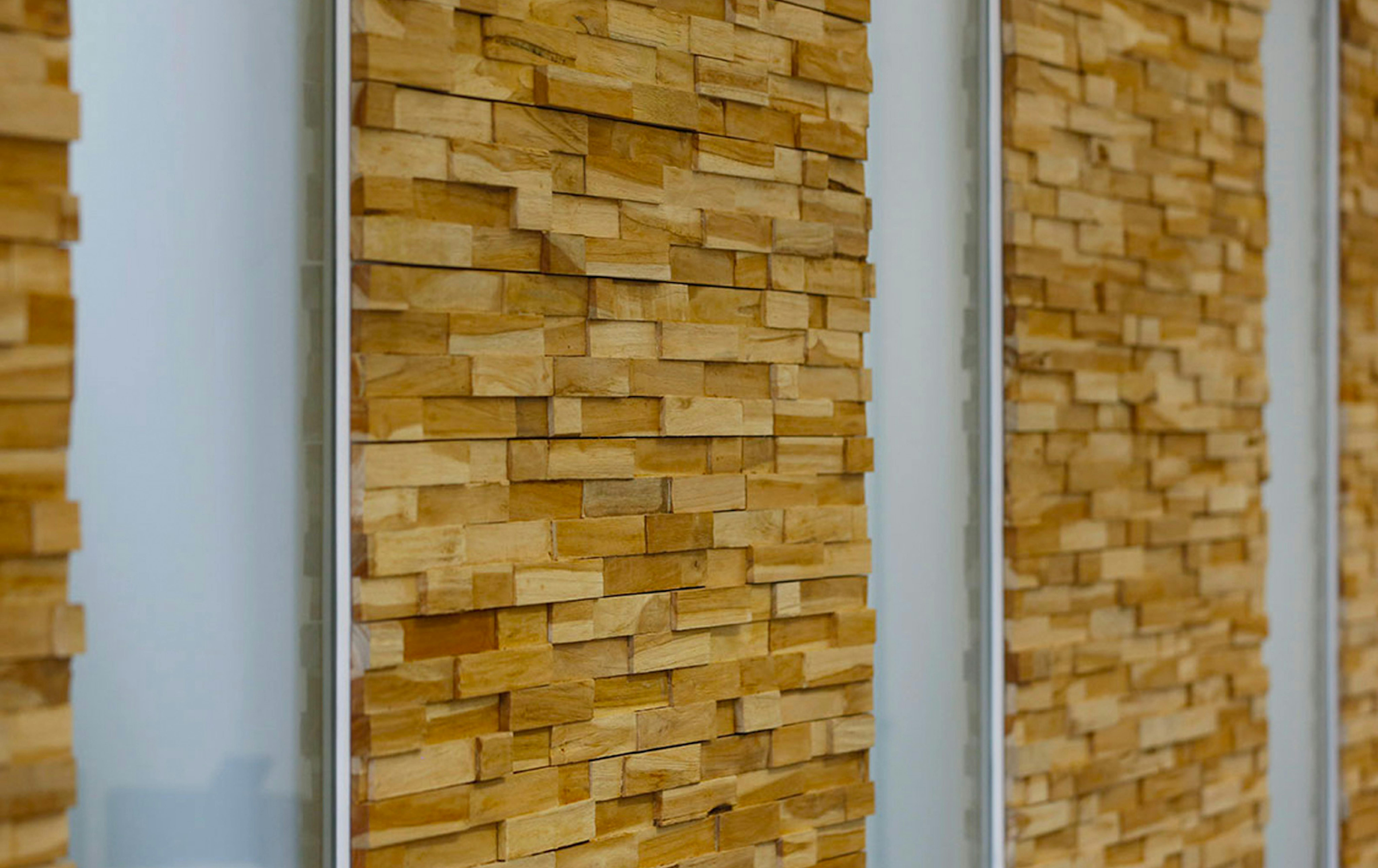 The door and surrounding wall surfaces -  finished in stacked timber blocks, creating texture and character.