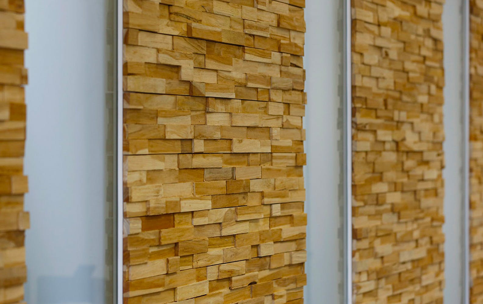 The door and surrounding wall surfaces -  finished in stacked timber blocks, creating texture and character.