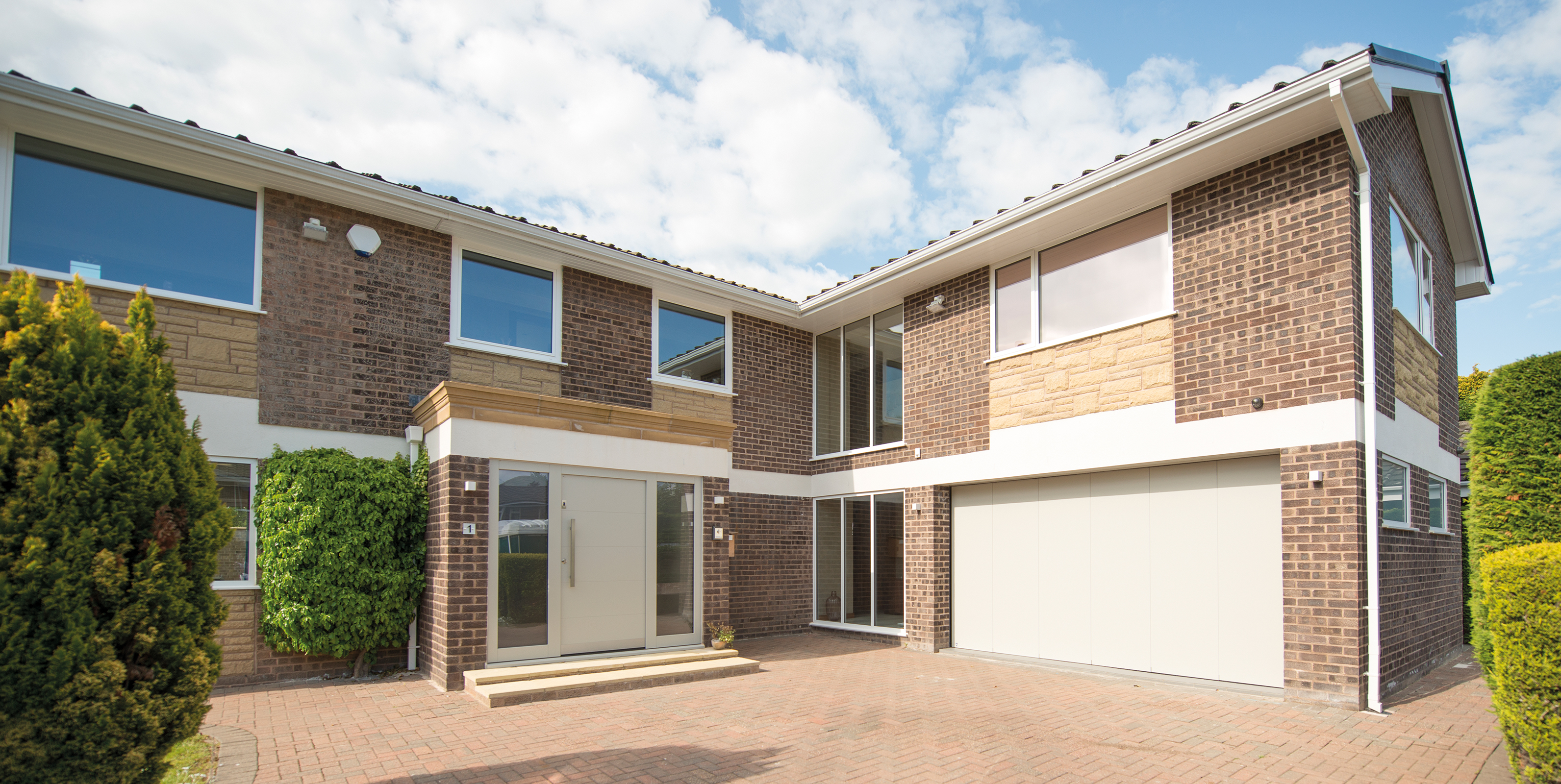 A modern house with matching white front and garage doors