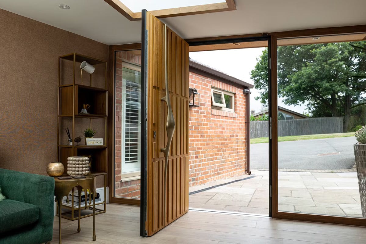 Internal view of a bespoke Deuren front door design with irregular linear detail across three rows - Tavole, Honey Oak with long sculptural handle.