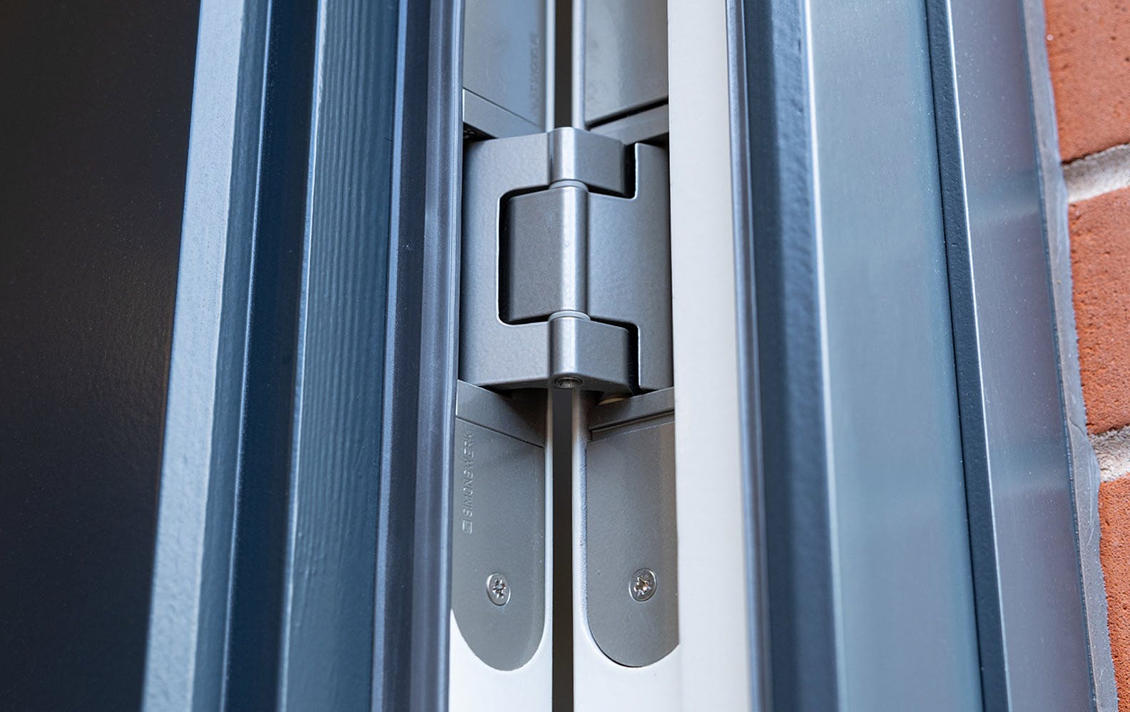 Close up of Simonswerk concealed hinges.