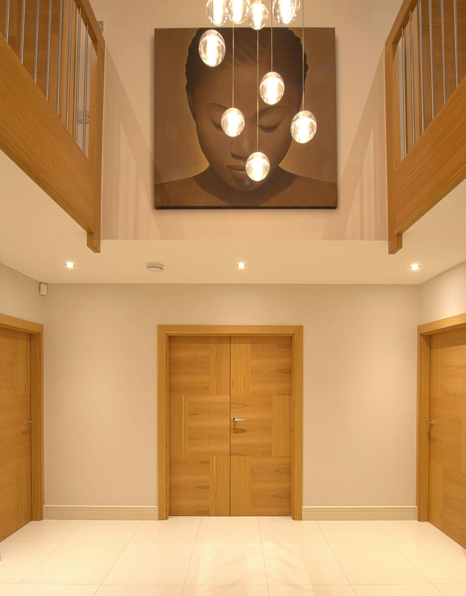 A spacious hallway featuring a Deuren double leaf, pre-hung door set - Vario 6 style in natural oak