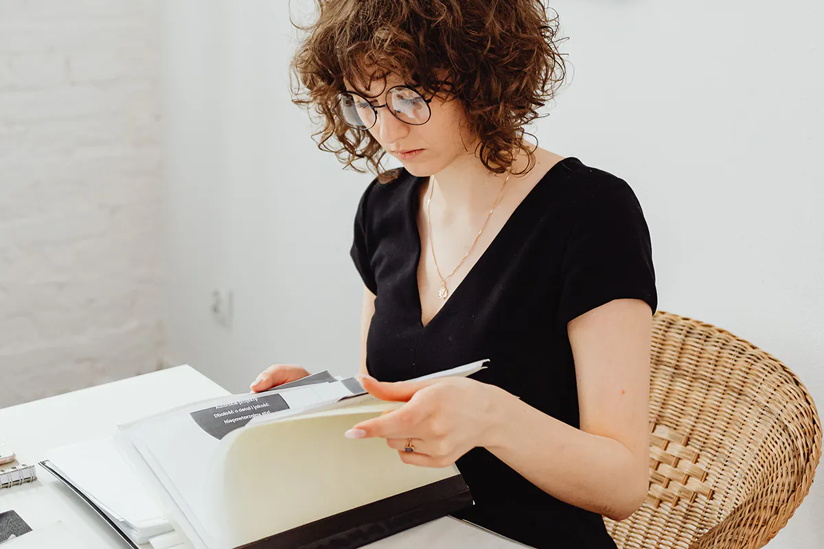 A young professional looking through a book.