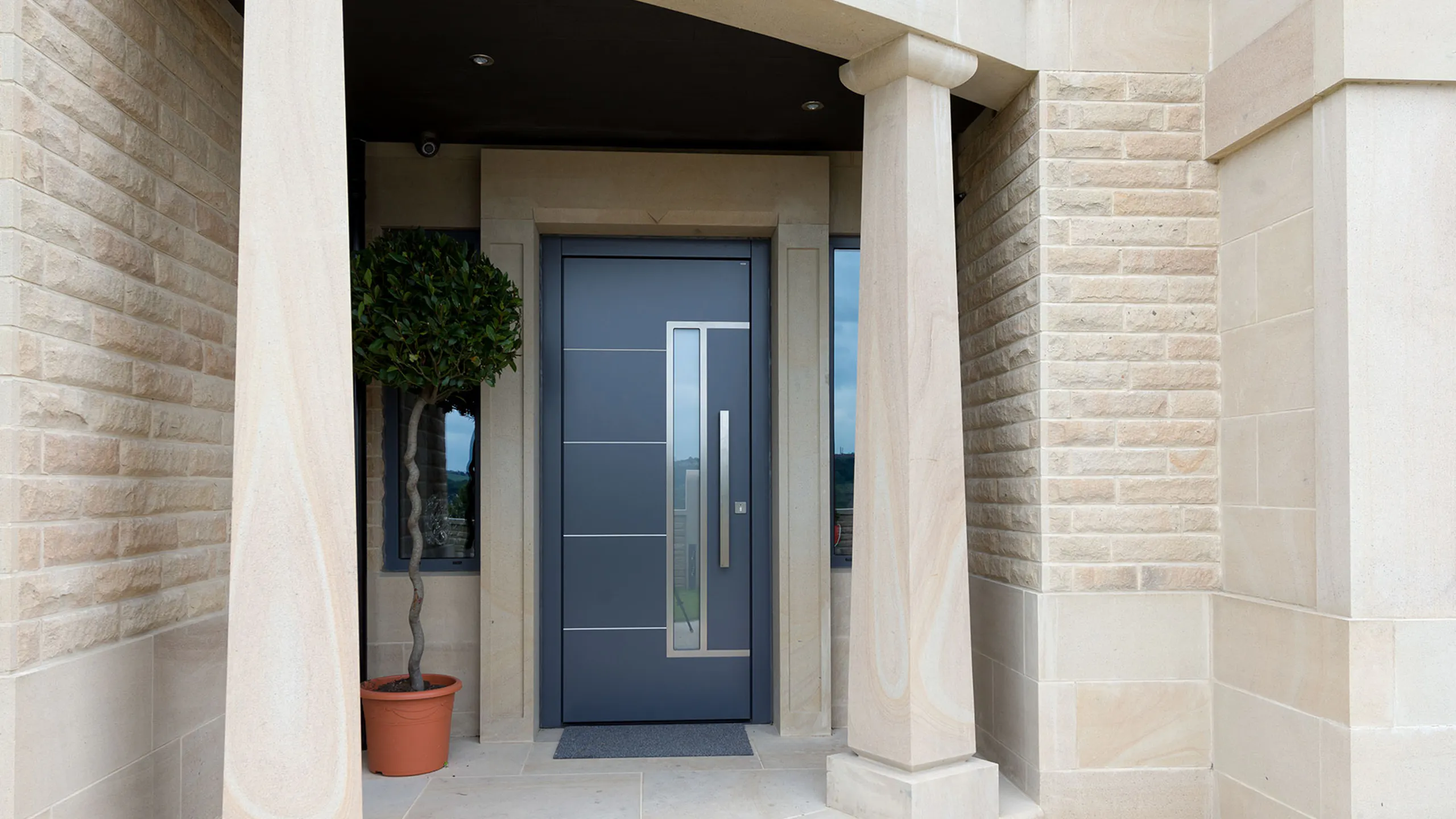 Blue front door with a stainless steel handle.