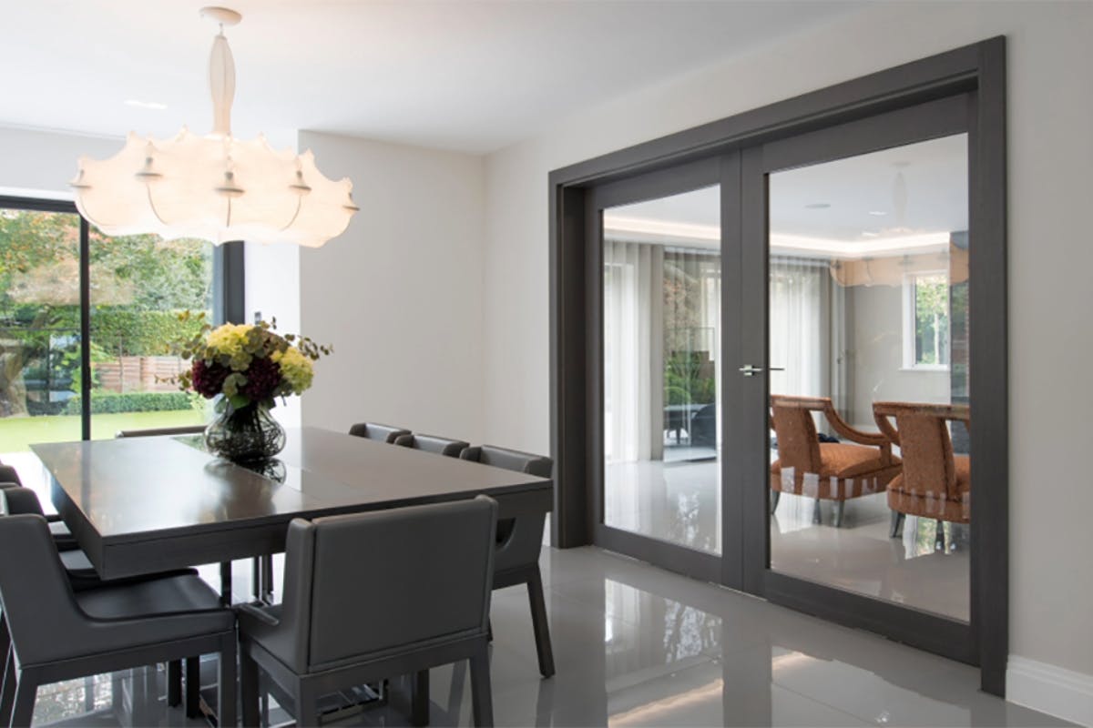 Contemporary dining room with double hinged doors in Gio glass, Grey Ash finish. 
