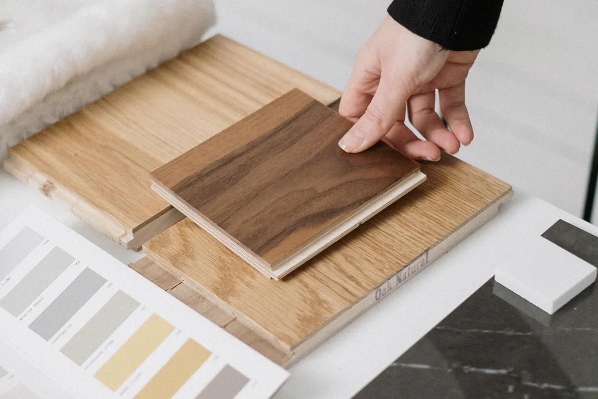 close-up of someone viewing different timber samples and paint colours