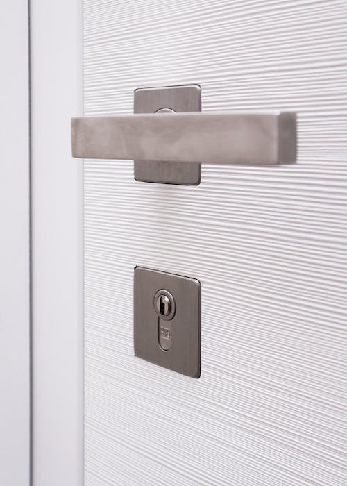 Close up of chrome door handle with key lock