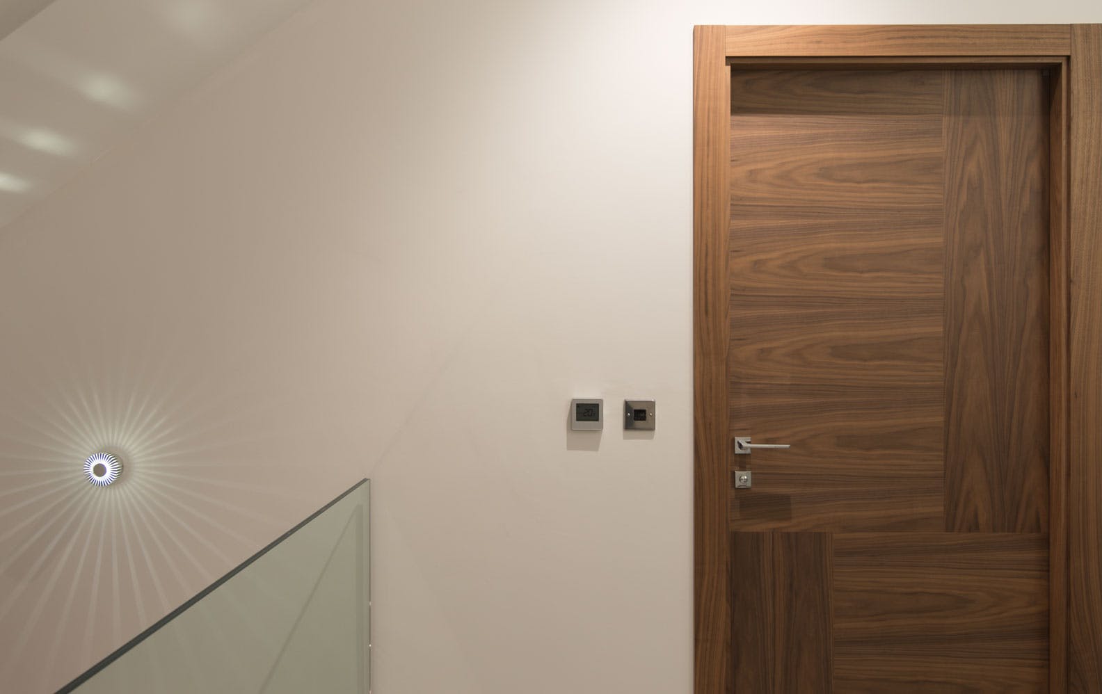 A made-to-measure interal door sets by Deuren - Vario 4 style, in a Walnut veneer, oriented in 4 ways.