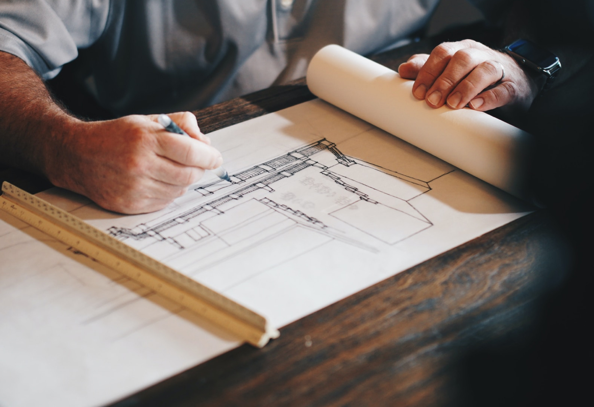 Architect drawing on architectural plans