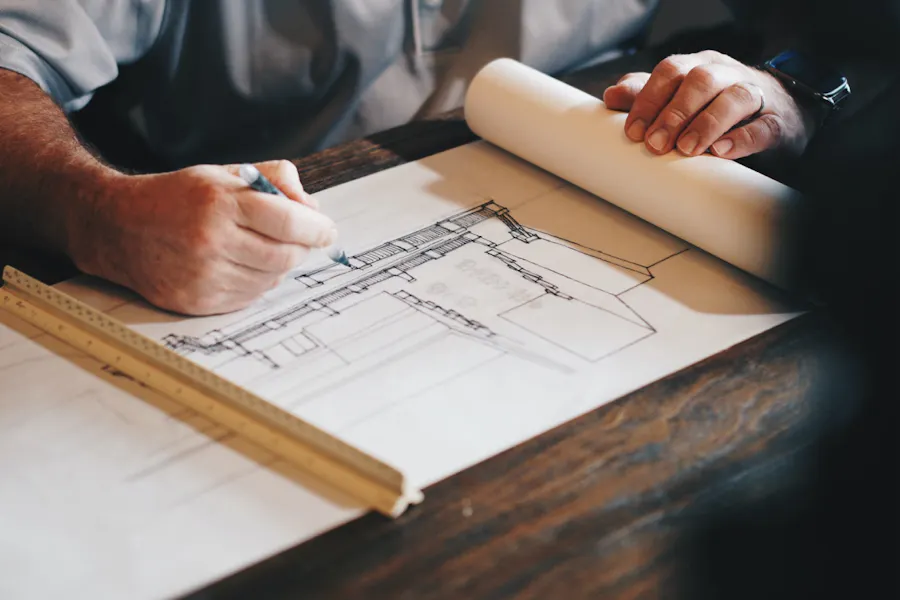 Architect drawing on architectural plans