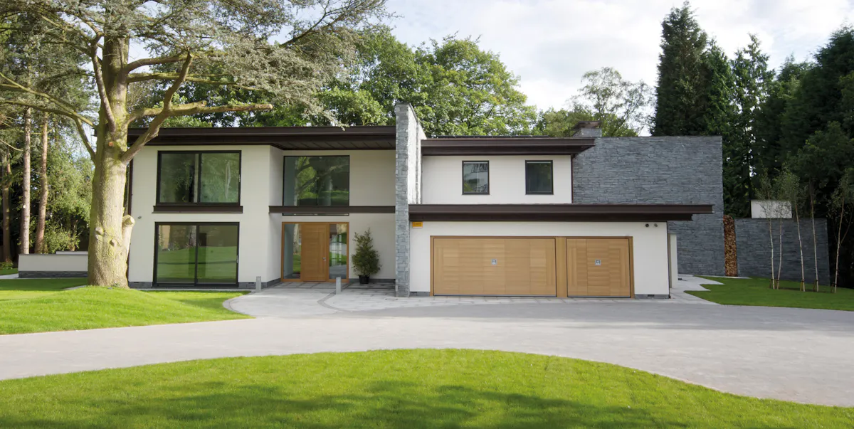 Modern house with wooden matching front and garage doors