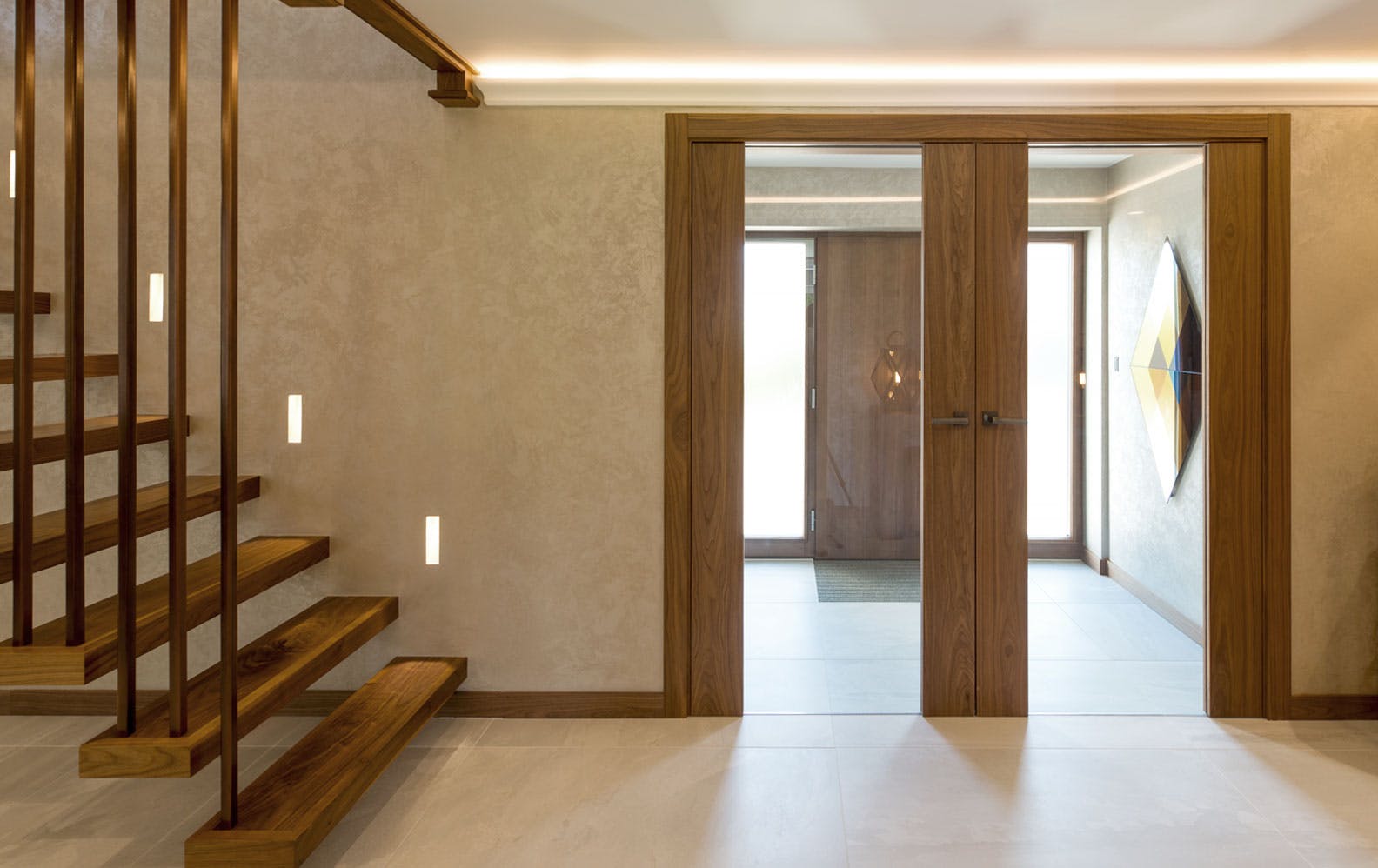 Modern hallway and staircase featuring a Double door set by Deuren - Style is Trem glazed, a full-height pane of clear glass held between two full-height strips of walnut veneered timber.