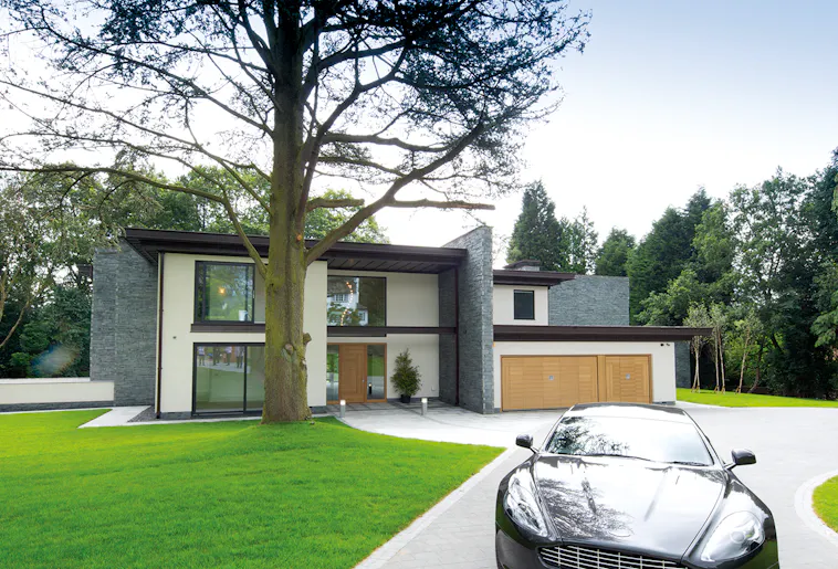 Modern house with wooden matching front and garage doors