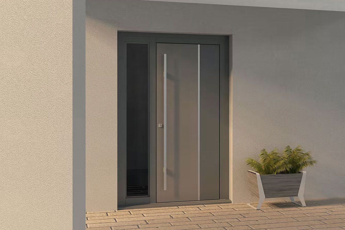 Contemporary front door by Deuren - Ness style has two vertical sections in different finishes (light and dark shades of grey) with a stainless steel inlay between the two sections and a long stainless steel bar handle.