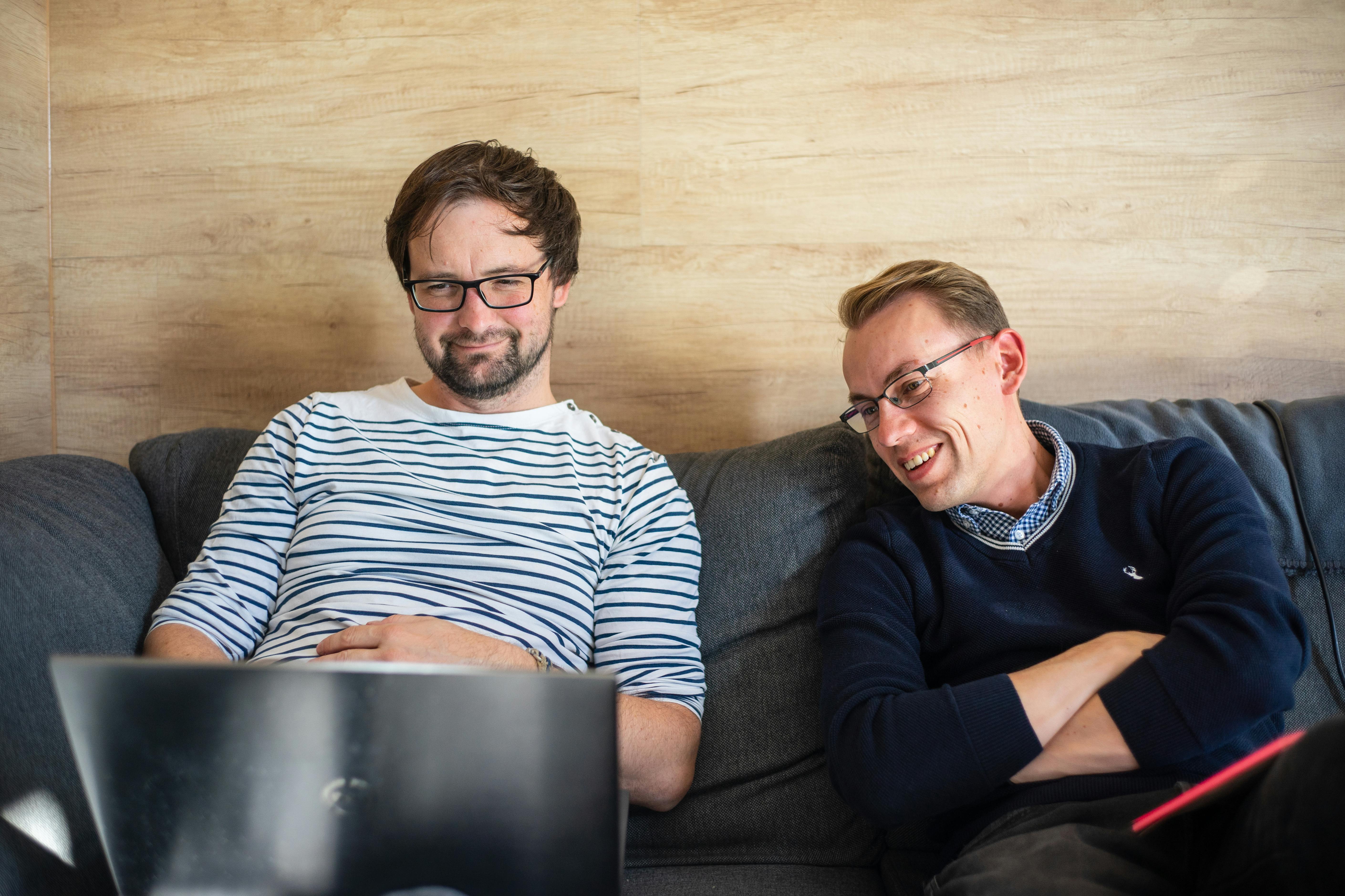 Two developers looking at a notebook screen