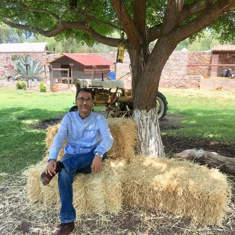 periodista sentado en pacas de paja