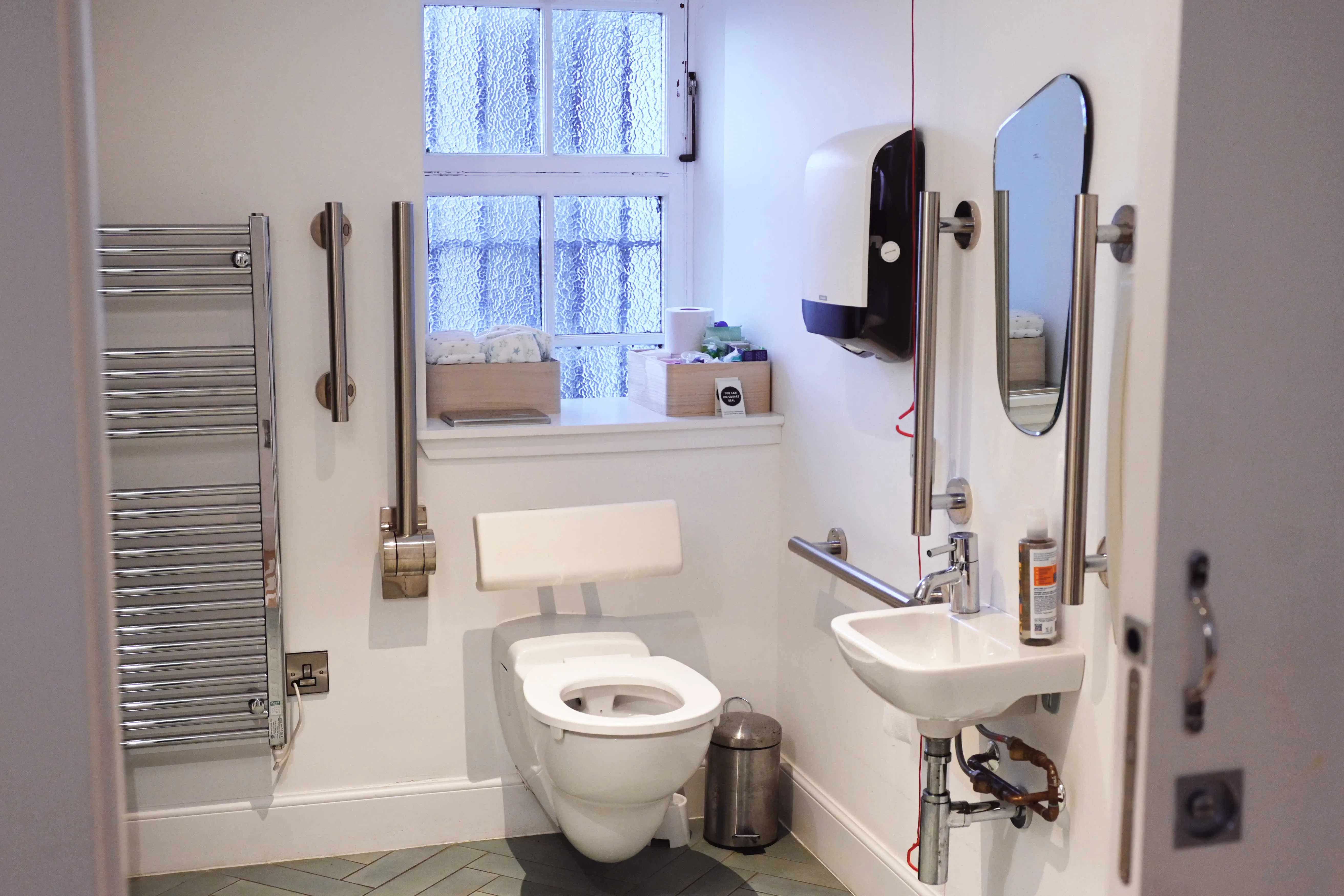 Square Deal toilet with grab rails and baby changing 