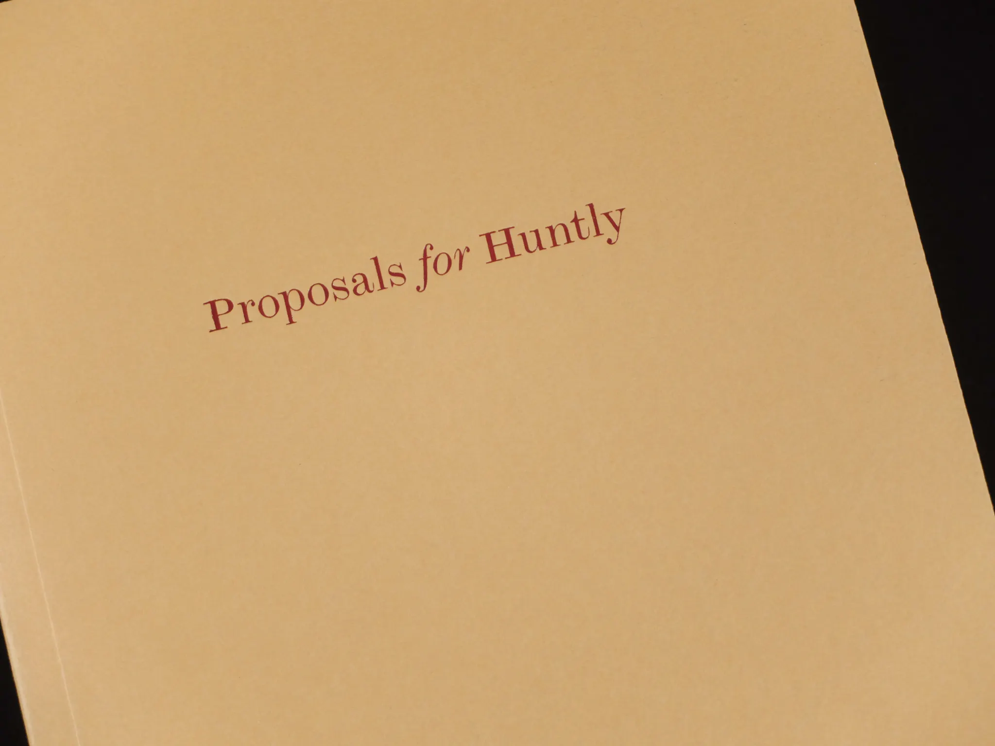 A close up of the book title, featuring 'Proposals for Huntly' typed in red on a brown background