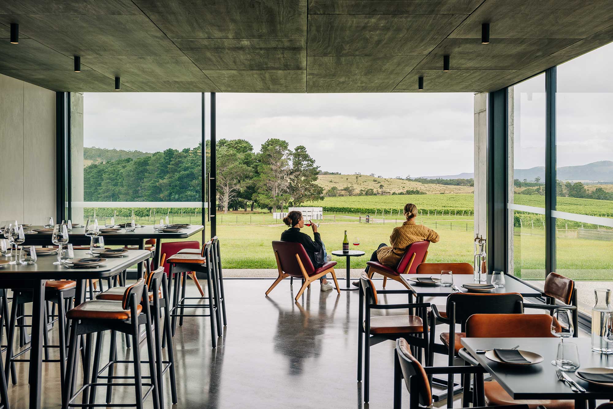 Image of two people sitting in the underground Devil's Den looking at the view