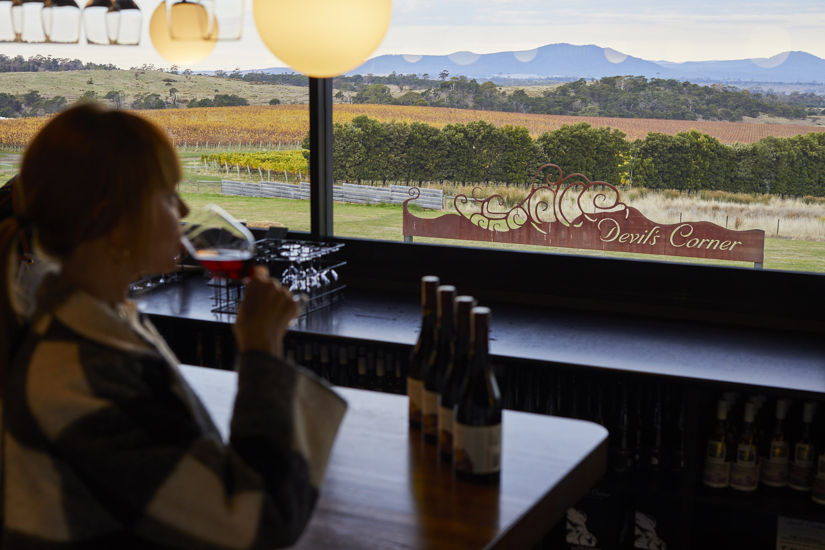 Woman drinking wine at the Tasting Bar in Cellar Door