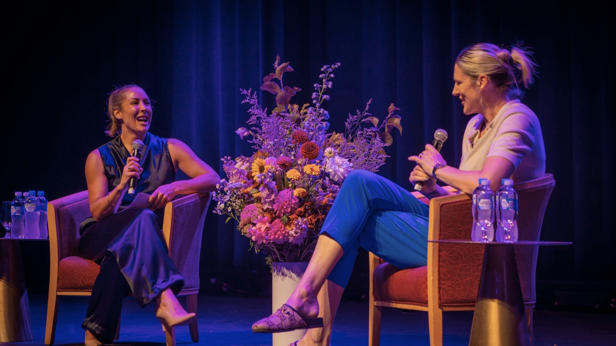 Lauren Jackson speaking at the panel at an International Women's Day event.