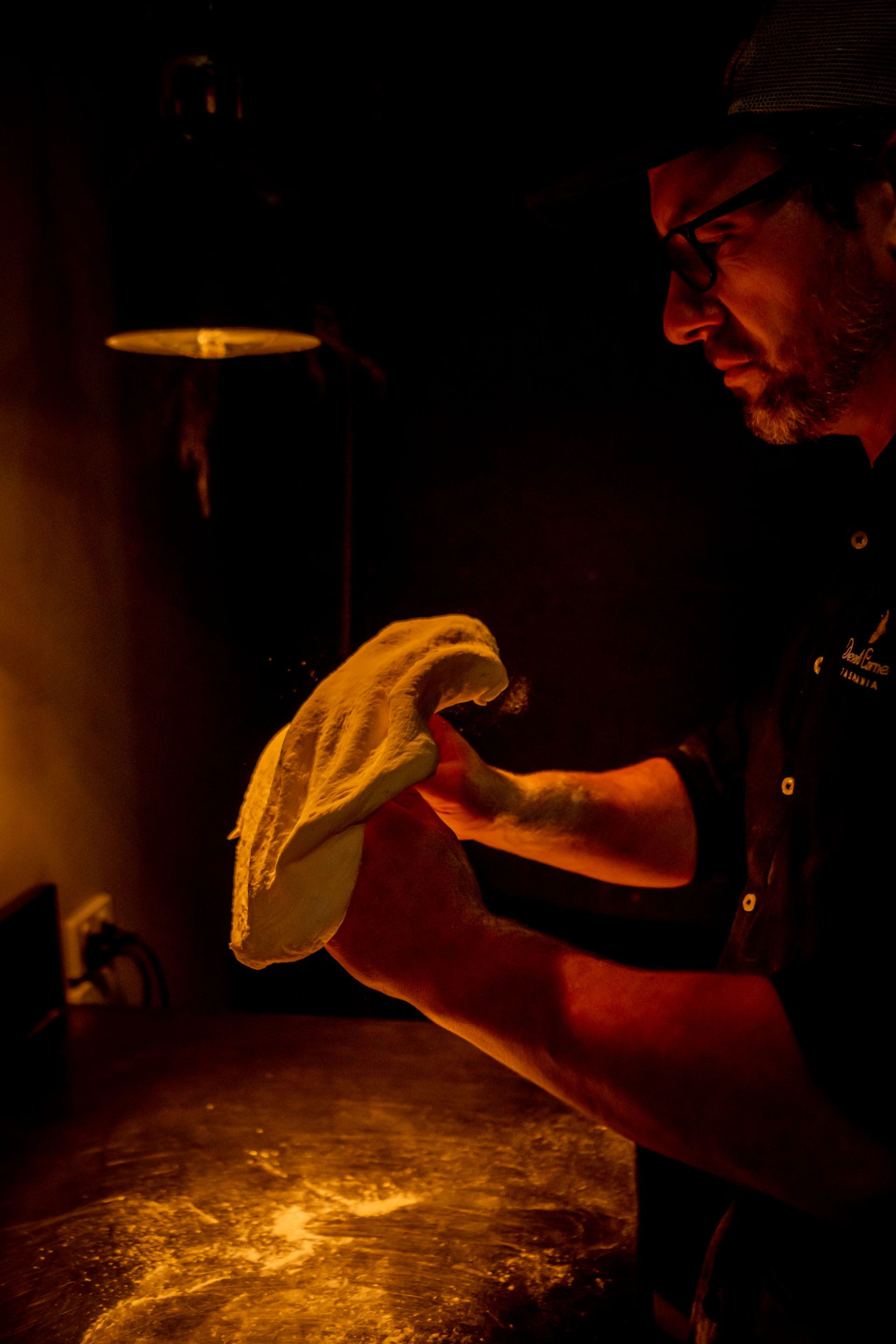 A chef spinning a pizza