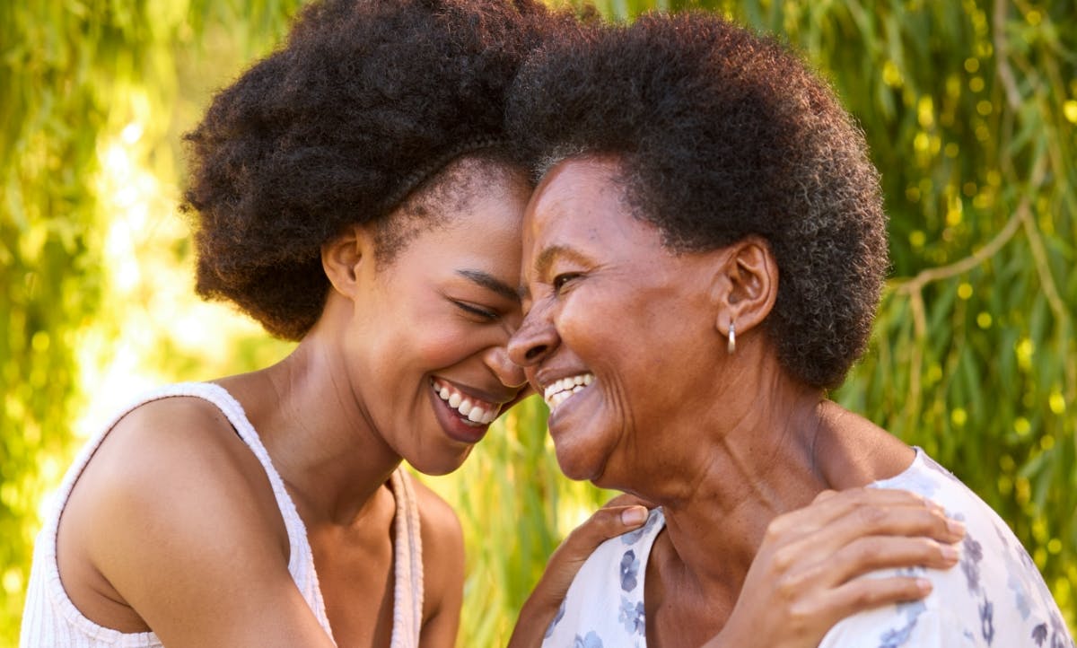 A grandmother and granddaughter laughing.