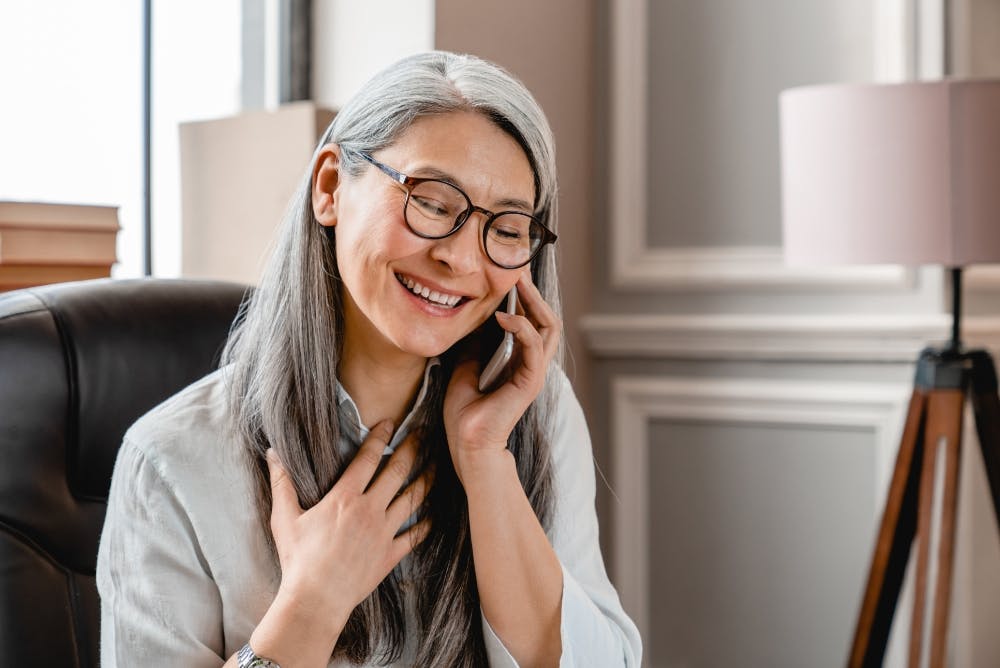 Older woman talking on the phone.