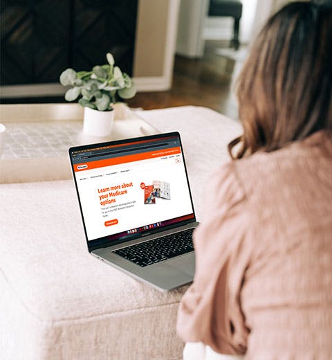 Woman looking at Devoted.com on her laptop.