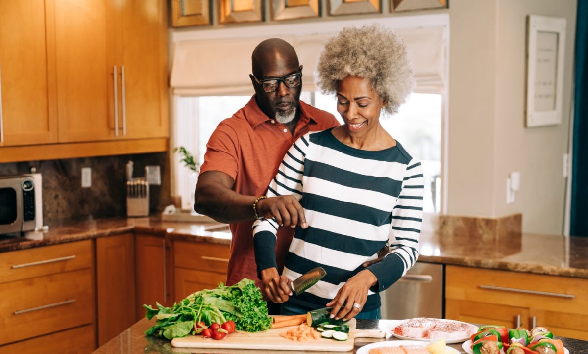 Man and woman cooking together in the kitchen.