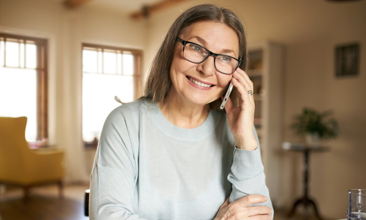 Woman smiling talking on the phone.