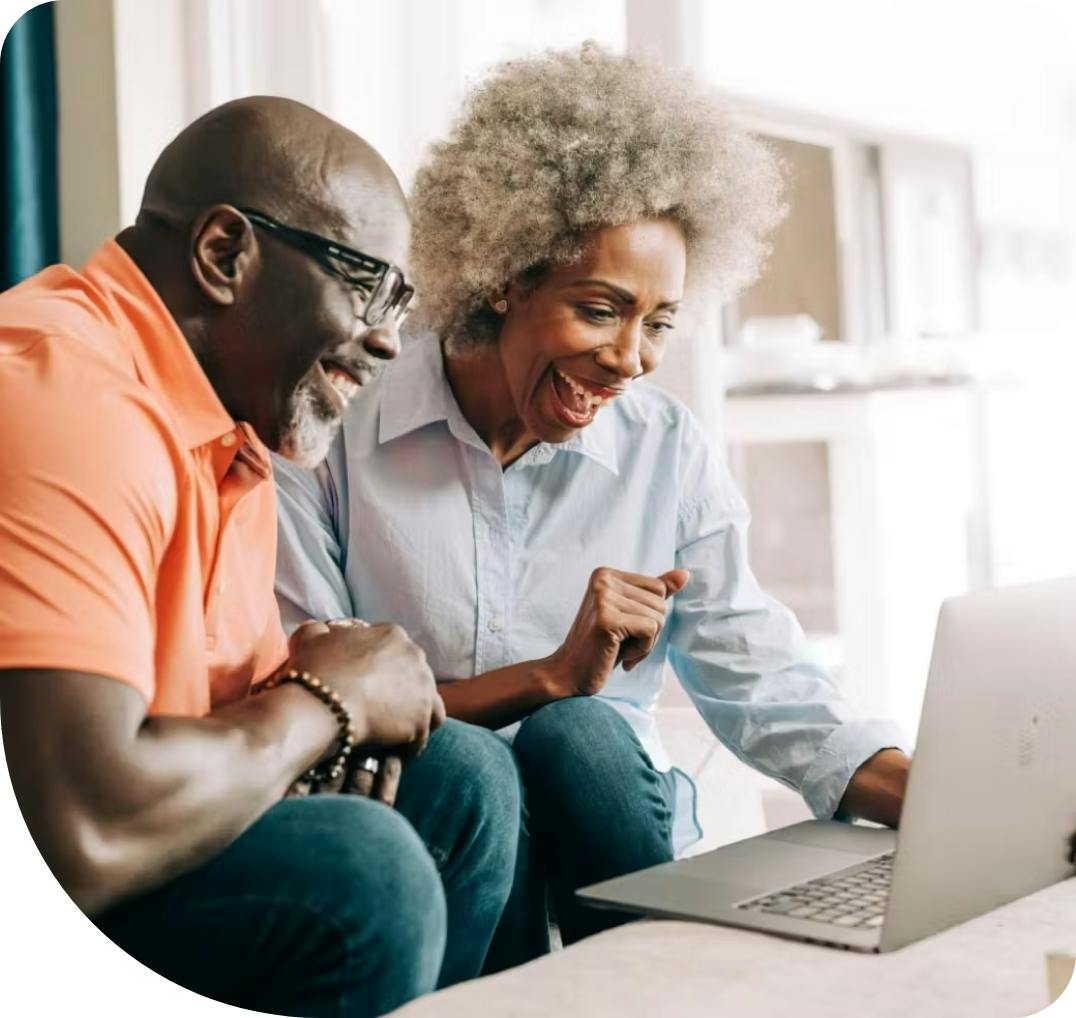 Man and woman looking at a laptop screen.