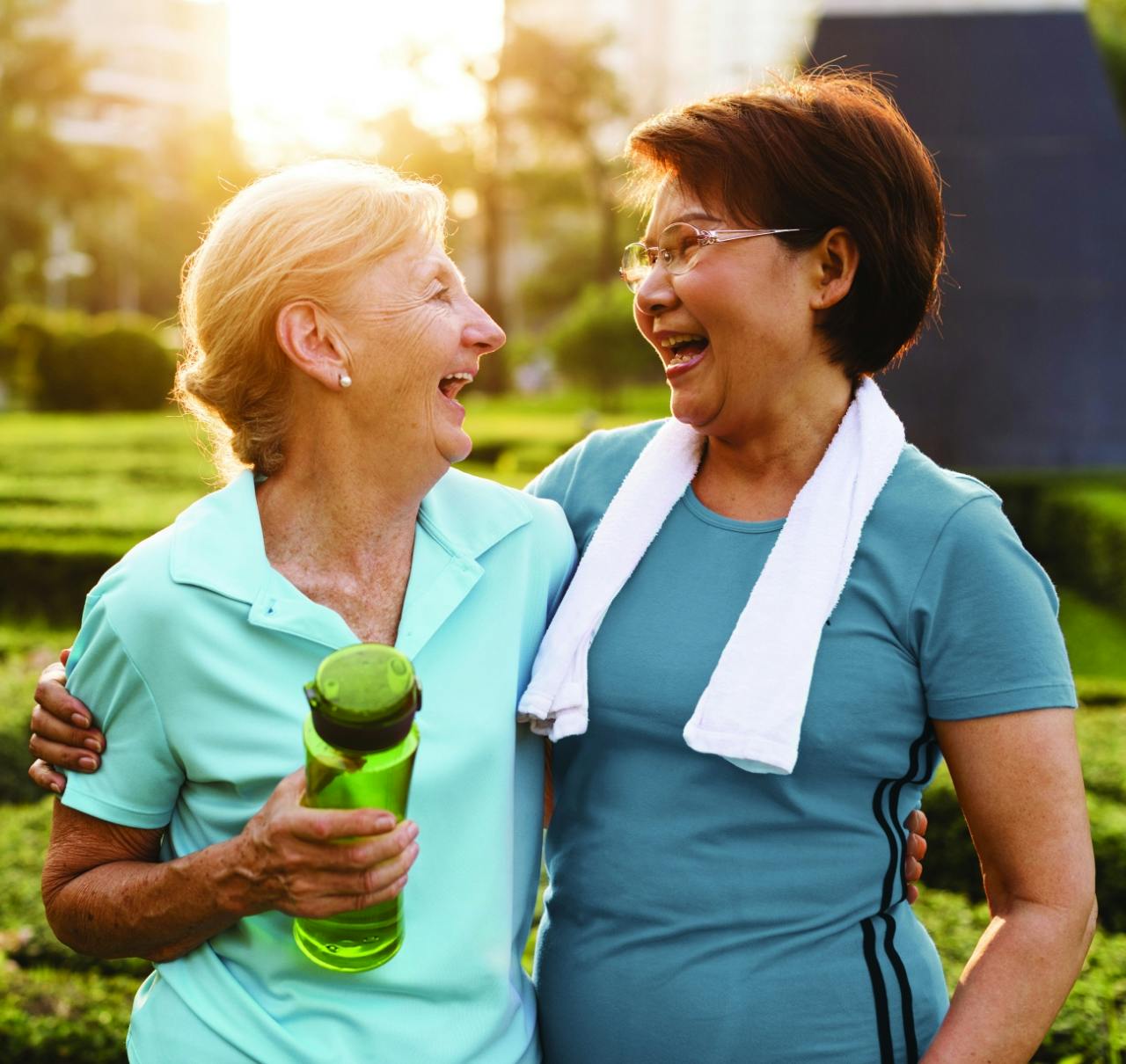 Two older women exercising together.