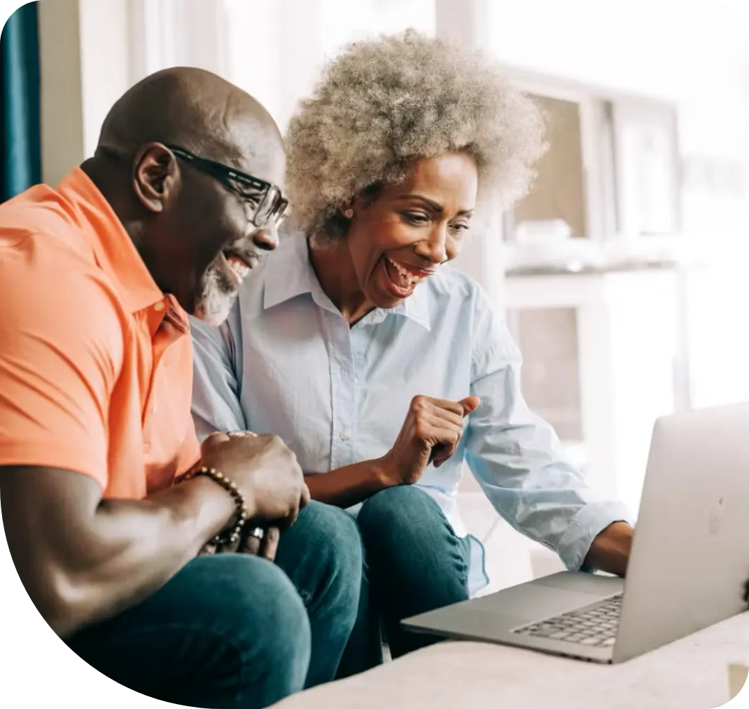 Man and woman looking at a laptop screen.