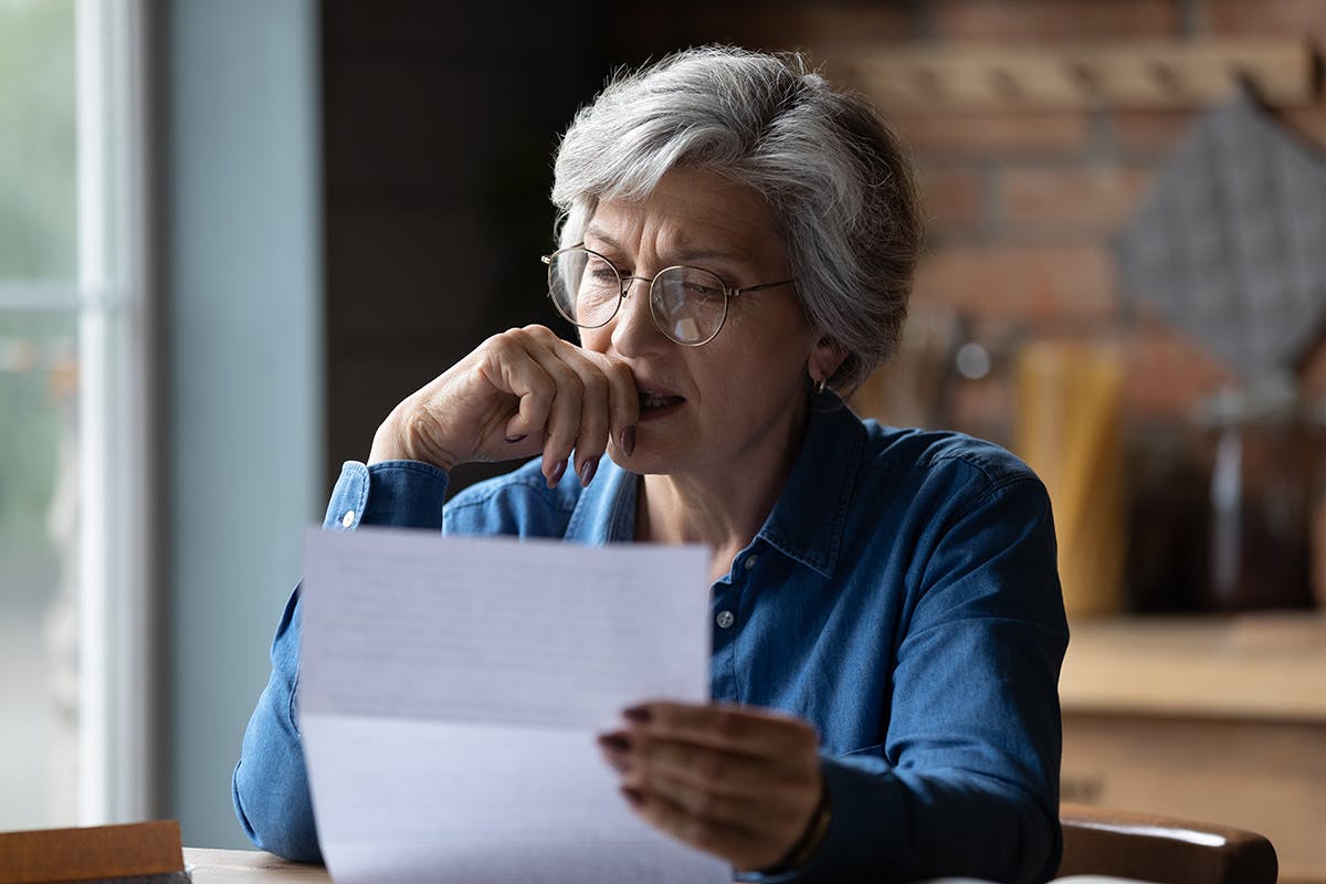 a woman looks at a letter