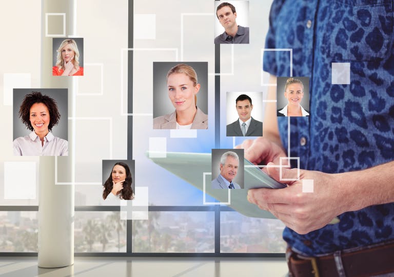 A man holding a tablet with different images of people.  