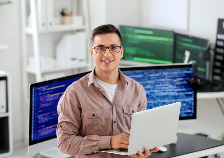 A man holding a laptop.