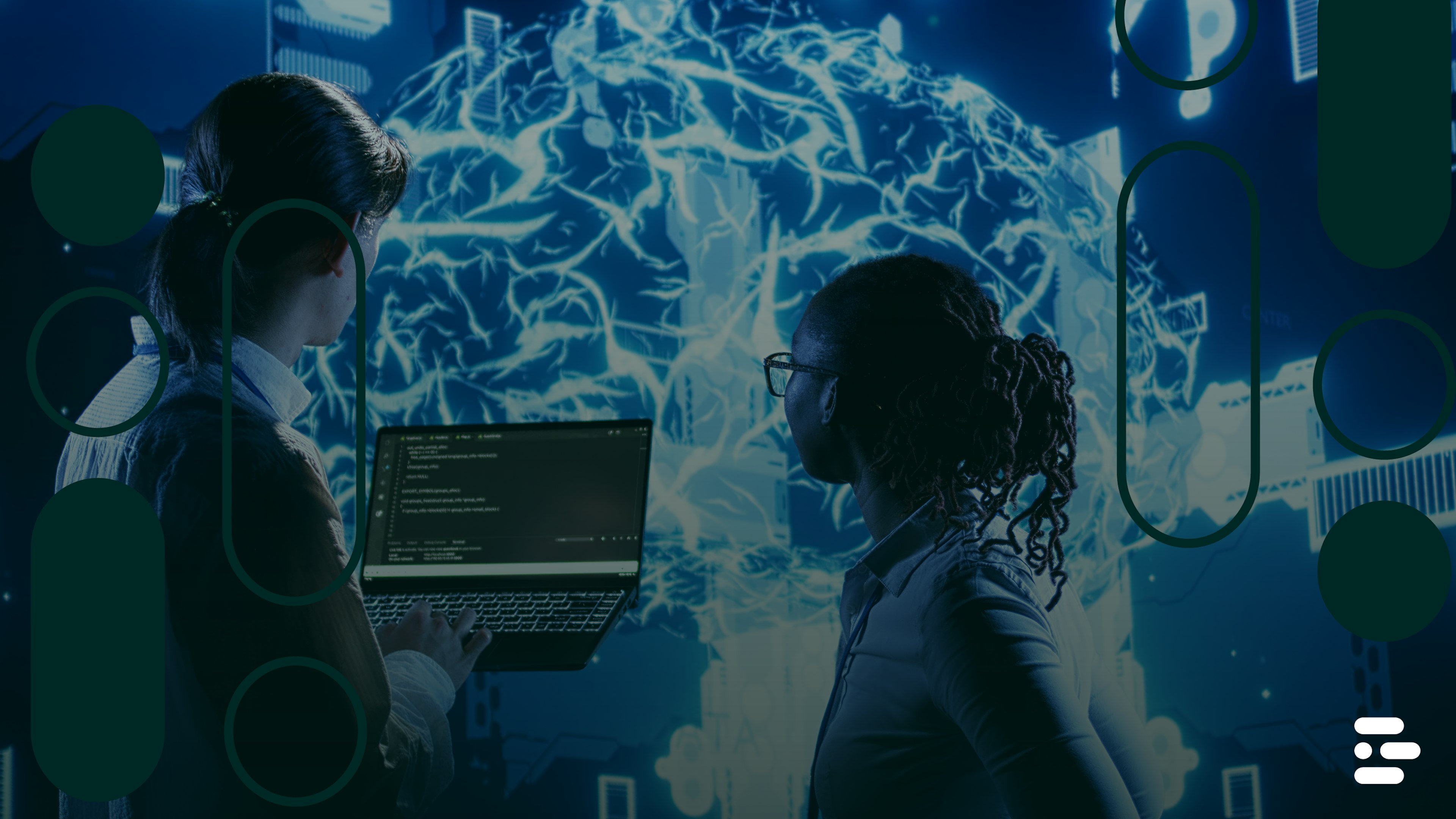 Two individuals examining code on a laptop